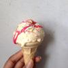 Homemade ice-cream drizzled with homemade strawberry sauce