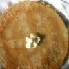Crispy, fluffy pancakes with butter and a maple syrup drizzle