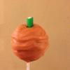 Orange style cake pops with orange interior, dipped in white chocolate(dyed red), and complete with an apple flavour log stalk(green candy)