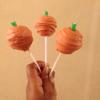 Orange style cake pops with orange interior, dipped in white chocolate(dyed red), and complete with an apple flavour log stalk(green candy)