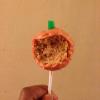 Orange style cake pops with orange interior, dipped in white chocolate(dyed red), and complete with an apple flavour log stalk(green candy)