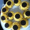 Sunflower muffins: Chocolate cake topped with Oreo and yellow icing piped around it.